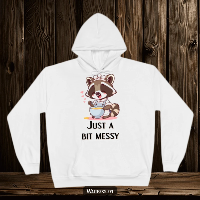 Soft, funny raccoon waitress hoodie showing a giggling raccoon spilling imaginary soup, ideal for staying warm and amused.
