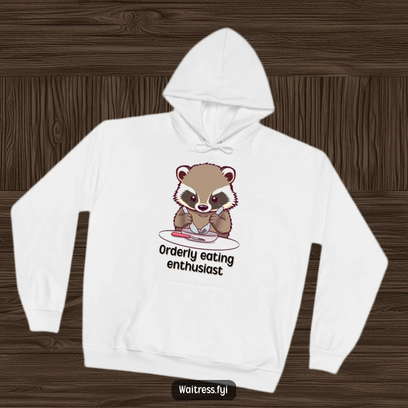 Funny Kawaii Badger Hoodie: A cuddly hoodie featuring a kawaii badger carefully arranging cutlery with great concentration.